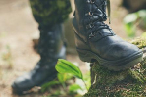 War, hiking, army and people concept - close up of soldier's foot in army boot